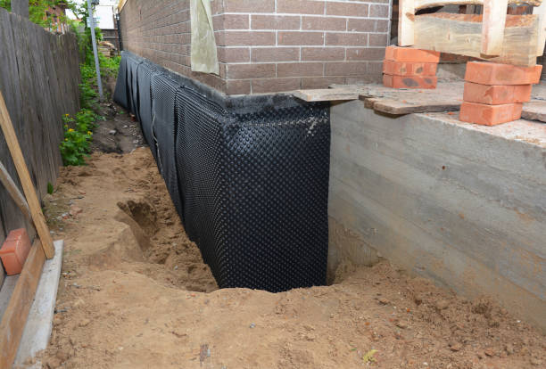 SJ Waterproofing Pros technician performing targeted Wet Basement Repair assessment in Westwood, KS